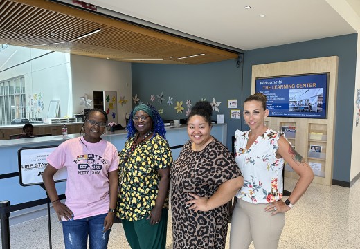 The Learning Center team stands by their front counter in Sage Hall. 